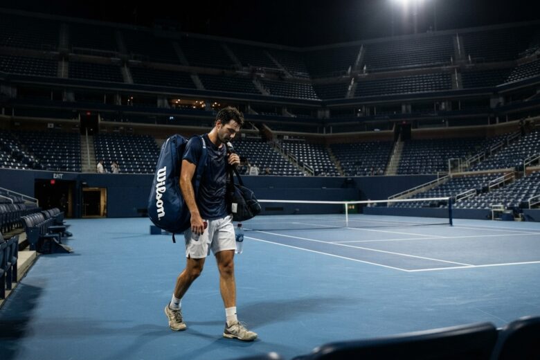 Tennis player leaving stadium court after defeat at night session