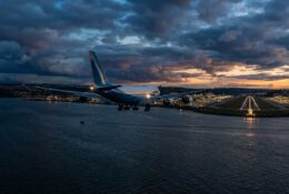 Cargo aircraft on final approach over water near airport