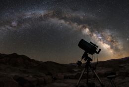 Night sky with stars and telescope silhouette during clear viewing conditions