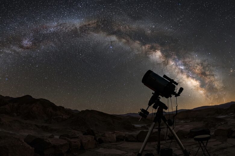 Night sky with stars and telescope silhouette during clear viewing conditions
