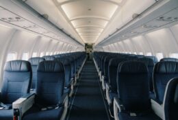 Commercial airplane passenger cabin interior with rows of seats